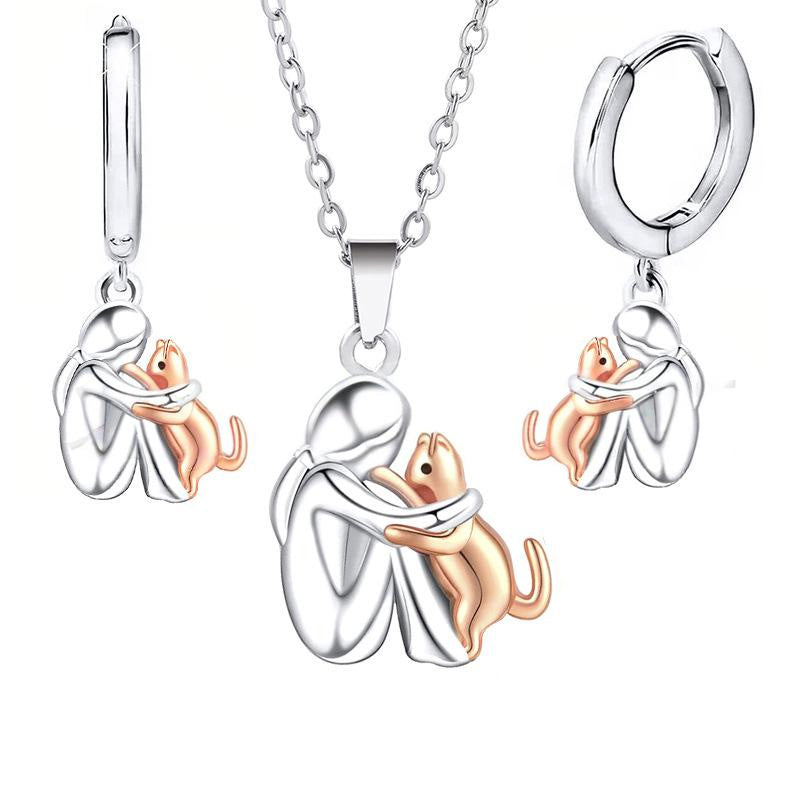 Petite Fille Câlinant un Chien – Clous d’Oreilles et Collier